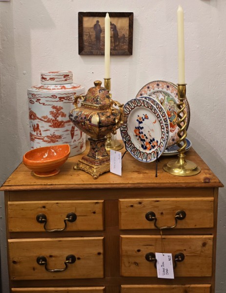 An Imari lidded jar, urn and plates styled on an antique pine chest of drawers