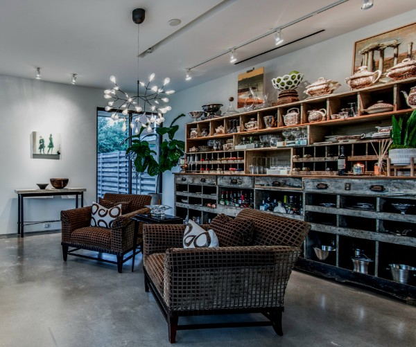 The Upcycle Designs showroom — walls of curated antiques, ceramics and glassware under gallery lighting